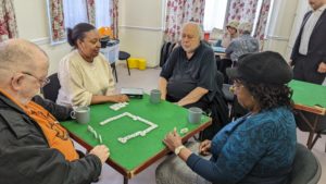 Beneficiaries of Link Age Southwark playing dominoes at the Wednesday social group