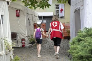 A Red Cross worker accompanies a child at the Red Cross Health Centre in Uzhhorod, eastern Ukraine.