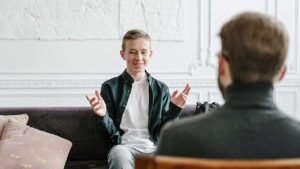 Boy sat in front of a therapist