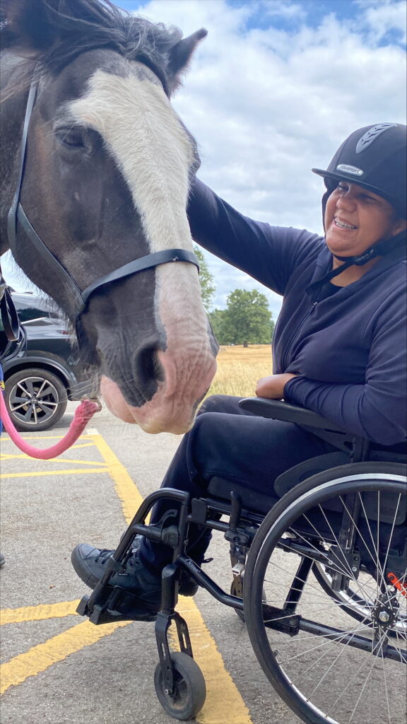 Lauryn petting a horse